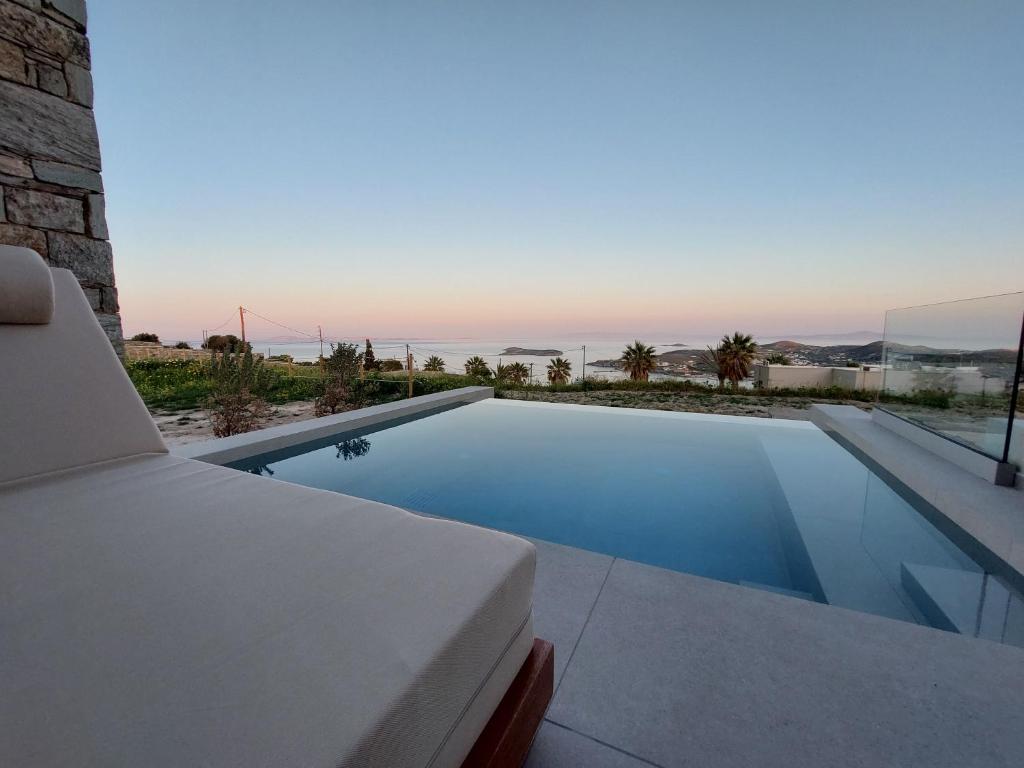 a swimming pool with a view of the ocean at Thea Syros in Ermoupoli