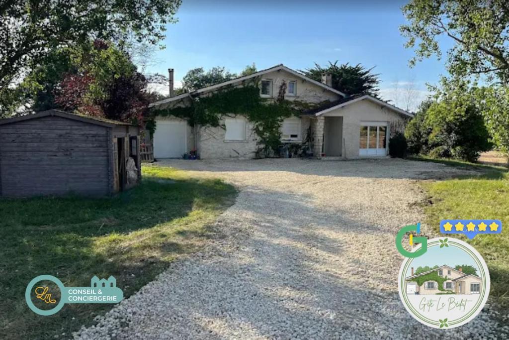 a house with a driveway in front of it at Gîte Le Bédat in Puycasquier