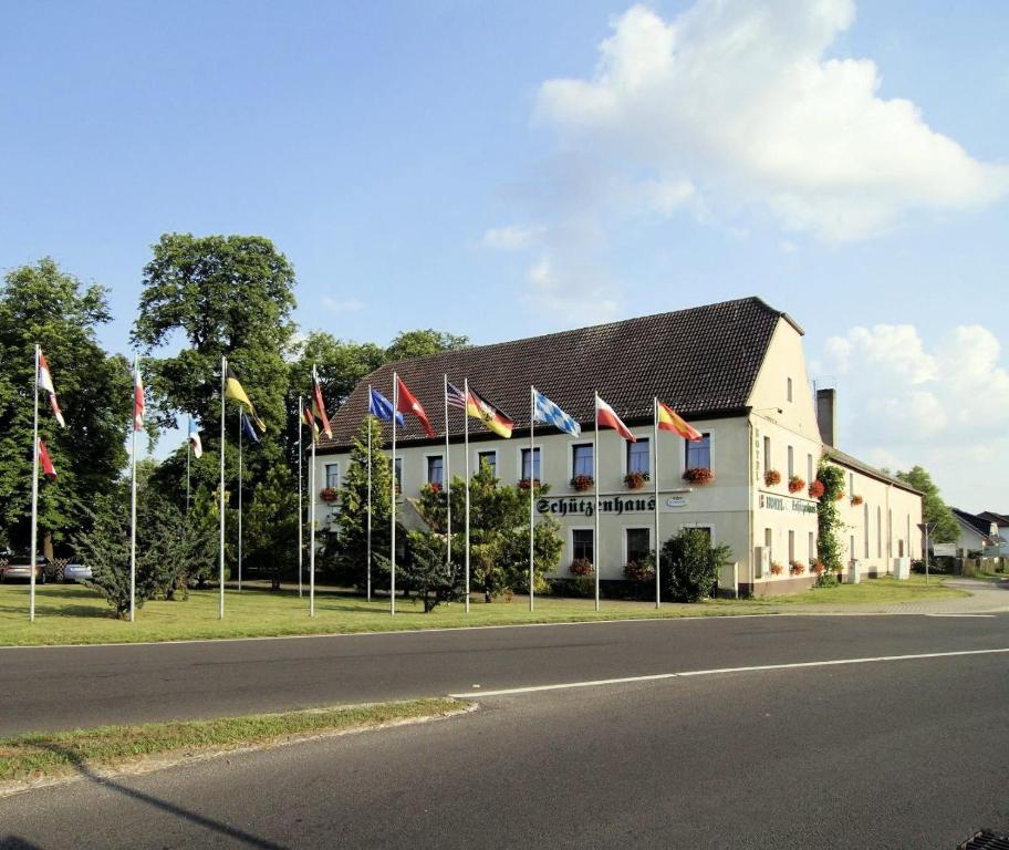 a row of flags in front of a building at Hotel Schützenhaus Jessen in Jessen