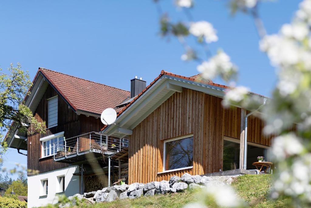a wooden house with the number on it at Tinyhaus Nähe Bodensee in Neukirch