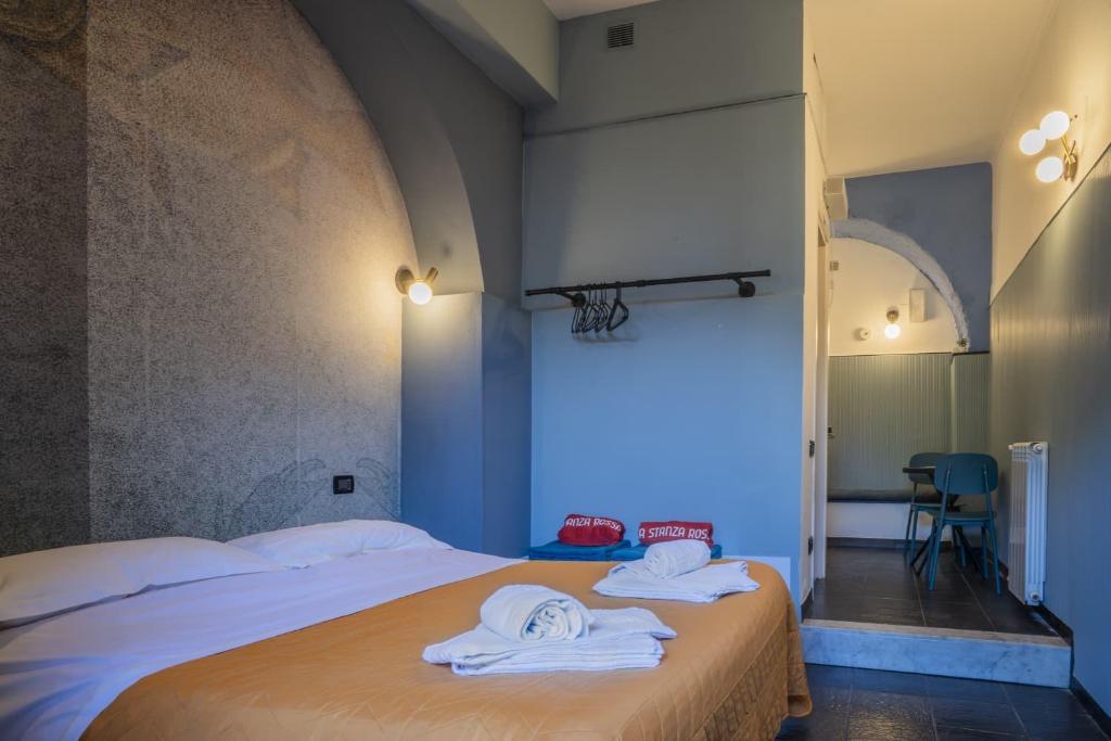 a bedroom with a bed with towels on it at La Stanza Rossa alle Cinque Terre in Manarola