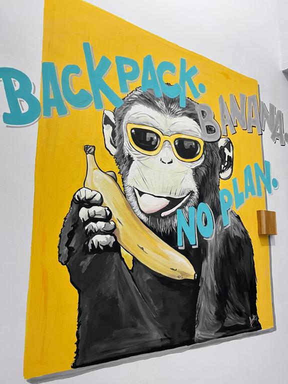 a painting of a monkey holding a banana at Terima Kasih Malang Hostel in Malang