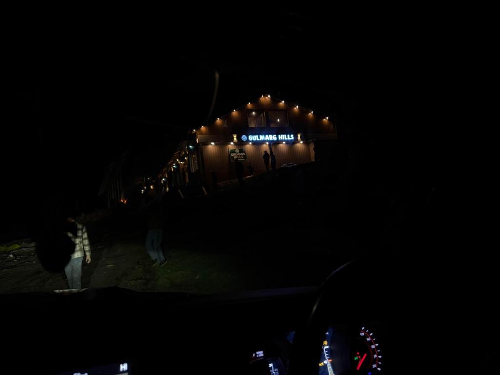a building lit up at night with lights on it at hotel gulmarg hills in Gulmarg