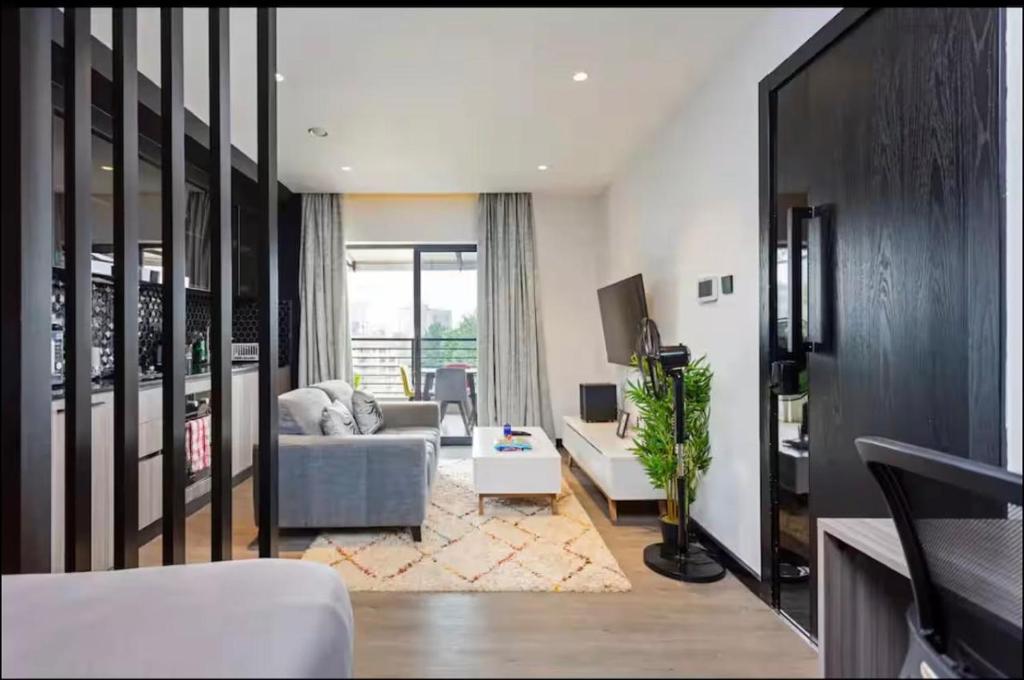 a living room with a couch and a table at Lifestyle Studio Apartment Escada 101 with Balcony in Nairobi