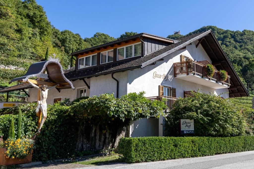 a house with a statue in front of it at Gass-Hof in Caldaro