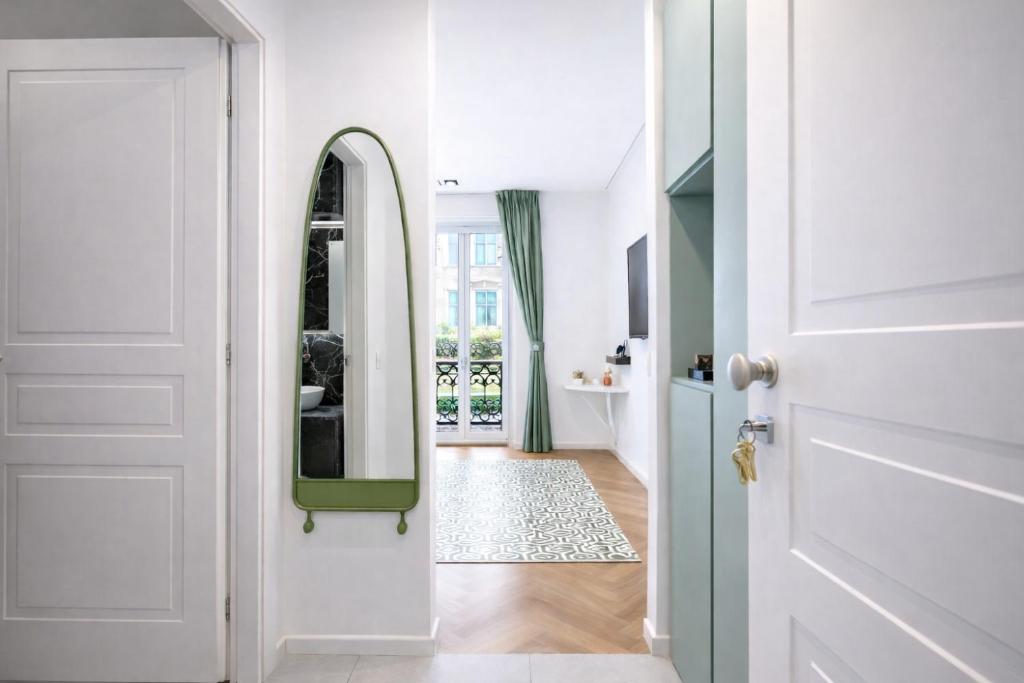 a hallway with a white door and a mirror at B and G San Babila- Luxury in the heart of Milano - Design district in Milan