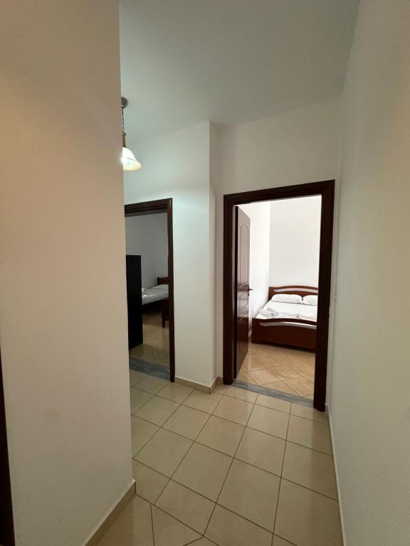 a room with a bedroom with a bed and a mirror at Vila Riviera in Ksamil