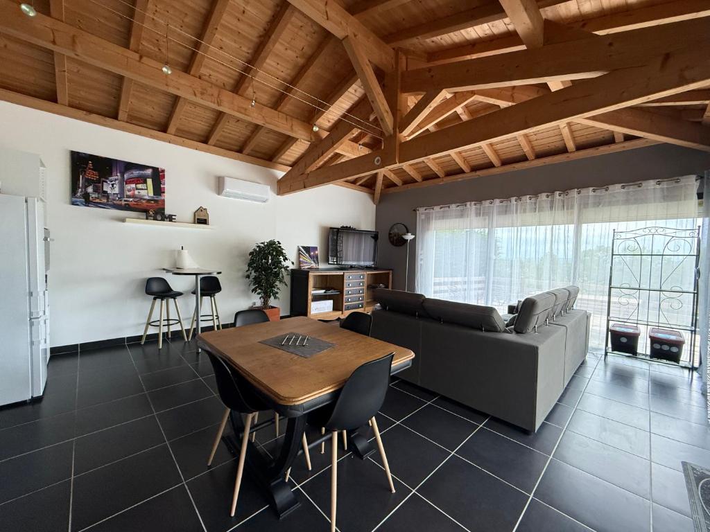 a living room with a table and a couch at Mon Hacienda in Caumont