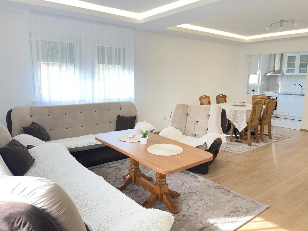 a living room with a couch and a table at Al Noor Villa Ilidža in Ilidža