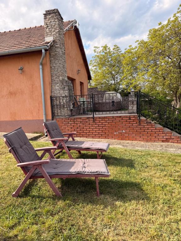 two chairs and a picnic table in a yard at GreenPark Candy Manor with Large Garden Close to Tokaj in Bekecs