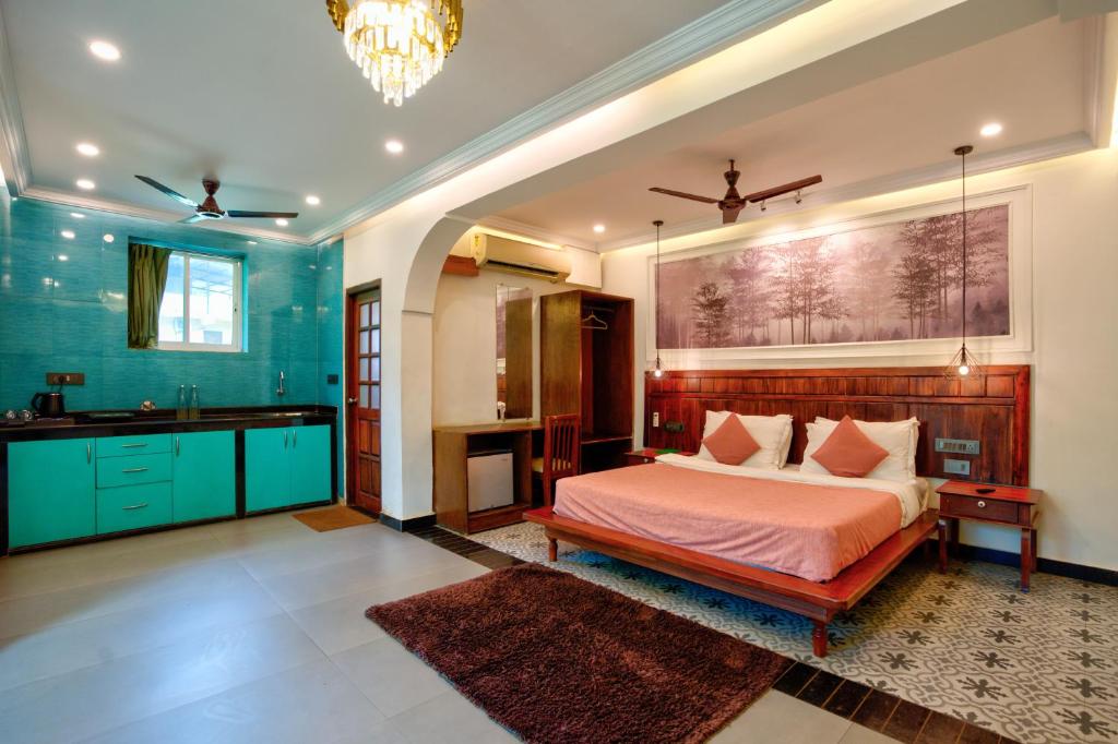 a bedroom with a bed and a sink in it at Bliss By Stays,Calangute in Calangute