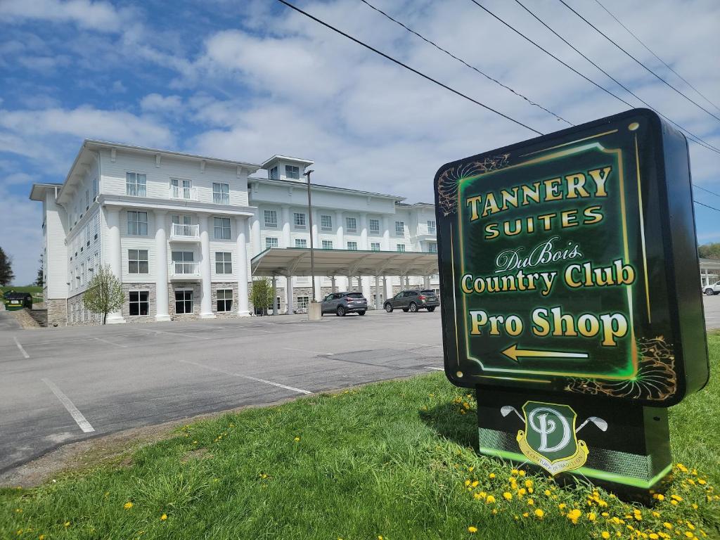 a sign in the grass in front of a building at Tannery Suites in DuBois