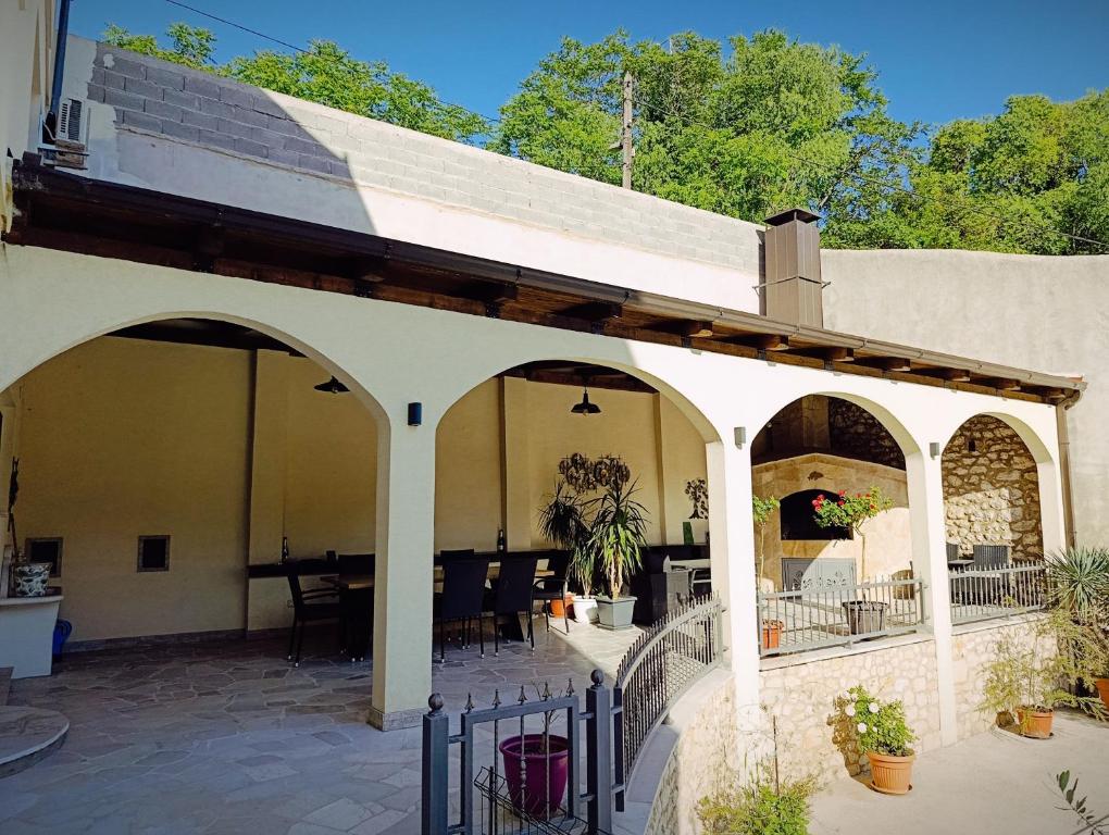 an outdoor patio with an archway and a table at Villa Olea in Mostar