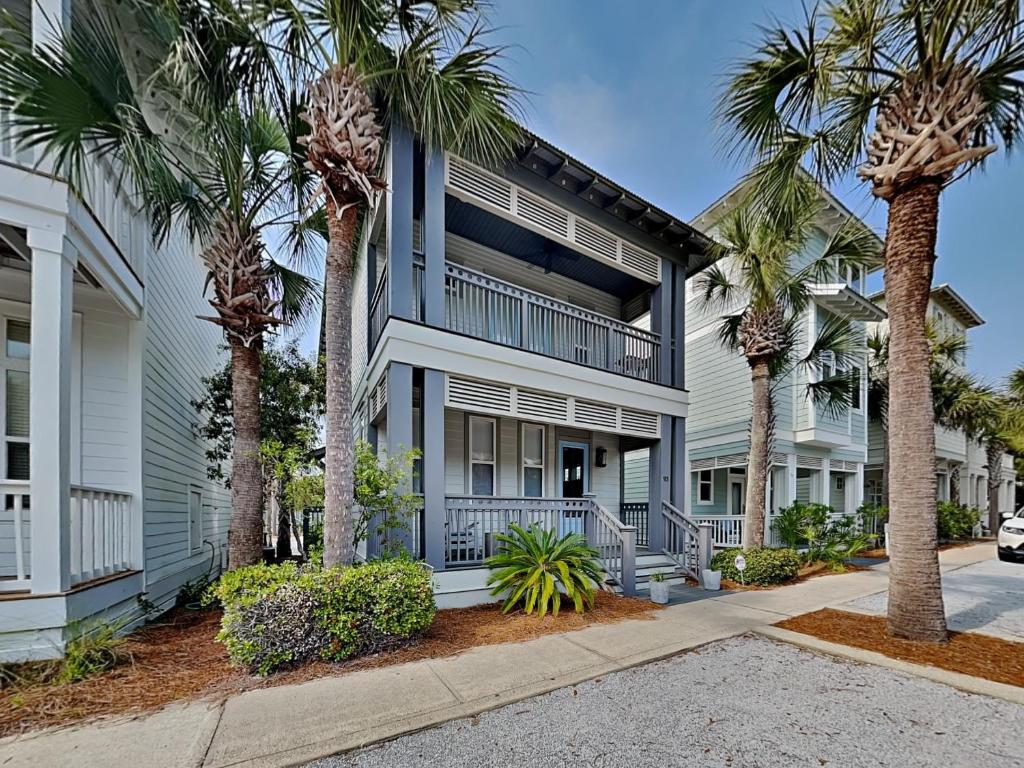 a building with palm trees in front of it at The Holland House II in Rosemary Beach