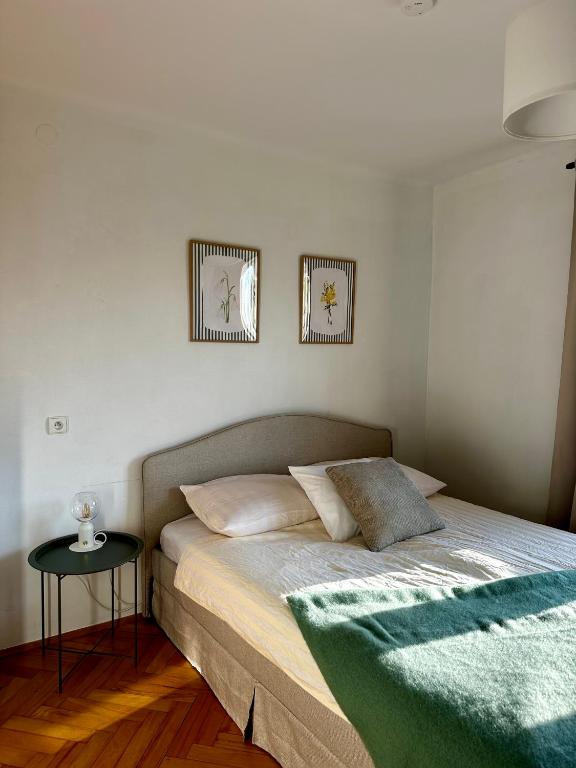 a bed in a bedroom with two pictures on the wall at POKLEKANE in Wysowa-Zdrój