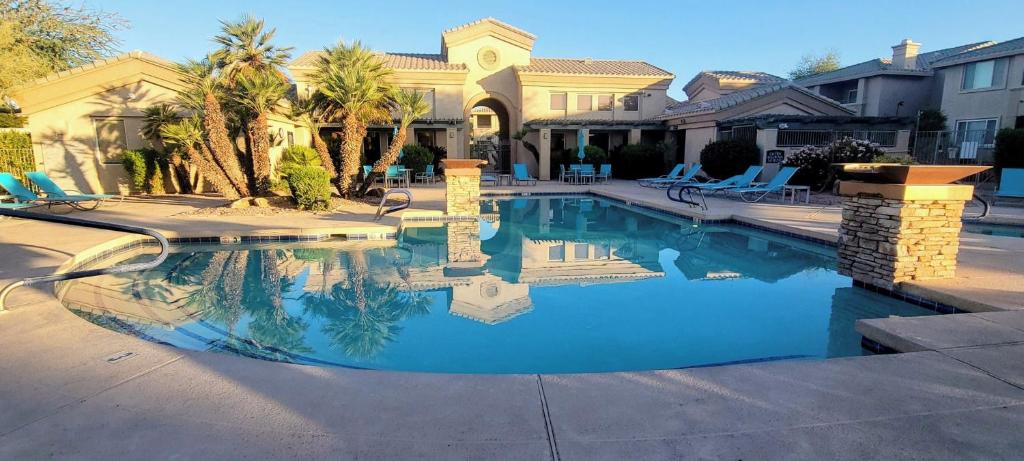 a swimming pool in front of a house at 2 Bedroom 2 Bathroom Ground Floor Condo Ahwatukee in Phoenix