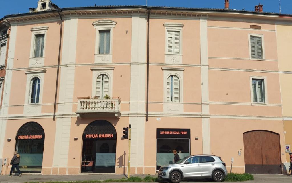 a building with a car parked in front of it at Millenovecento in Cremona