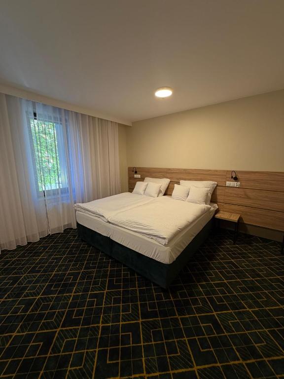 a bedroom with a large bed in a room at Royal Apartamenty in Bytom