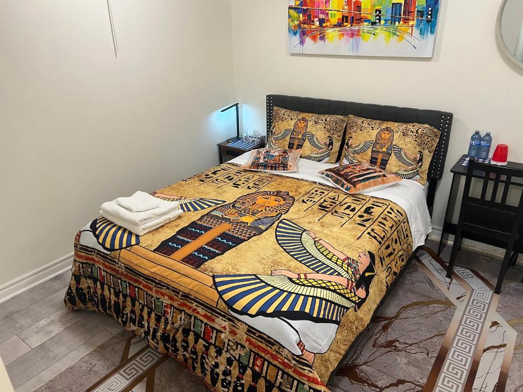 a bedroom with a bed with a colorful blanket on it at Stylish City Escape in Toronto