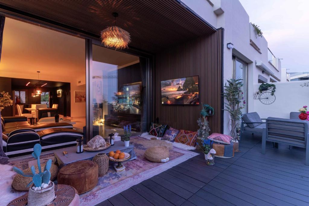 a patio with a living room and a couch at VIP AL FATTAh LUXURY in Estepona