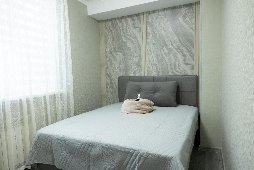 a bedroom with a bed with a towel on it at Apartaments Miro in Chişinău