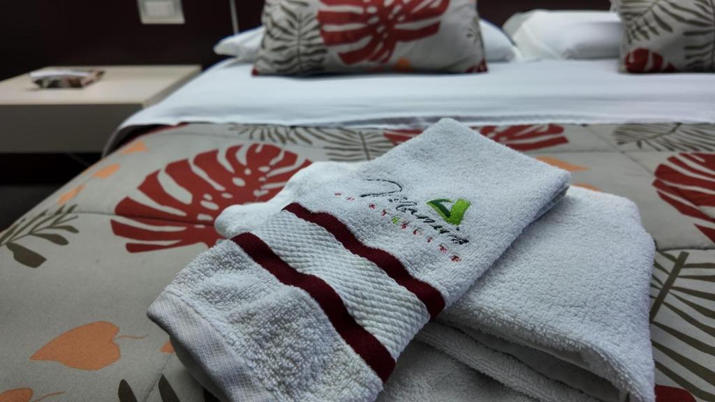 a bed with towels sitting on top of it at Manu's Guest Suite in Cosenza