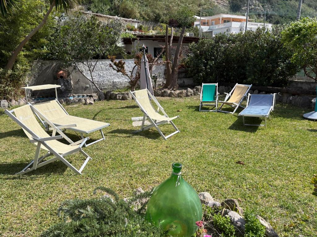 a group of lawn chairs sitting in the grass at Villa Maria Citara Beach in Forio d'Ischia