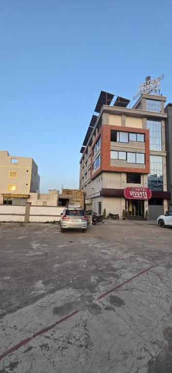 an empty parking lot in front of a building at Hotel Vivanta Inn Somnath in Somnath