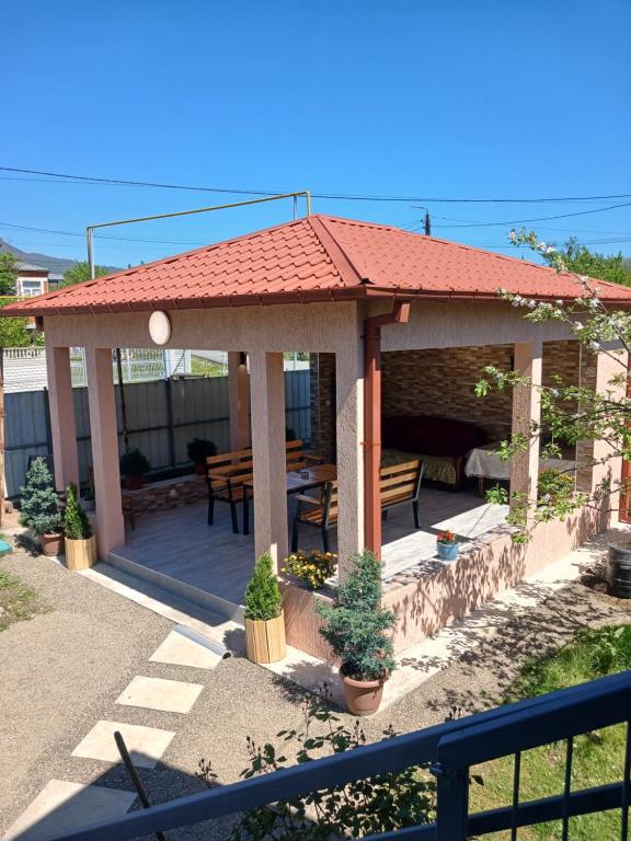 a gazebo with a table and a bench at Guest house Nano in Martvili
