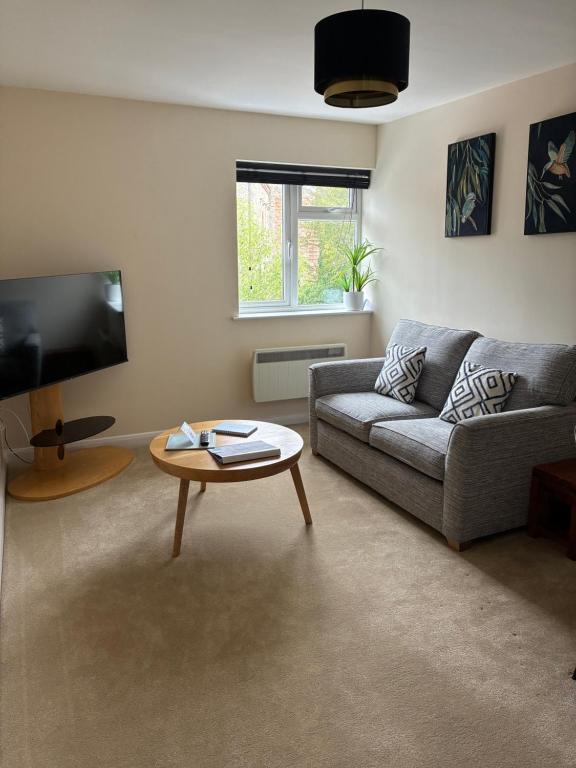 a living room with a couch and a coffee table at Wookey Holiday Flat in Wookey