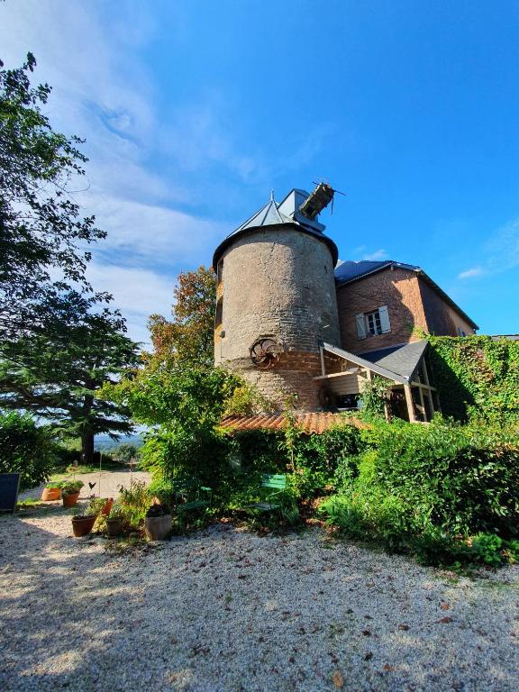 a building with a tower on top of it at Gîte La Tour du Moulin in Saint-Étienne-de-Montluc