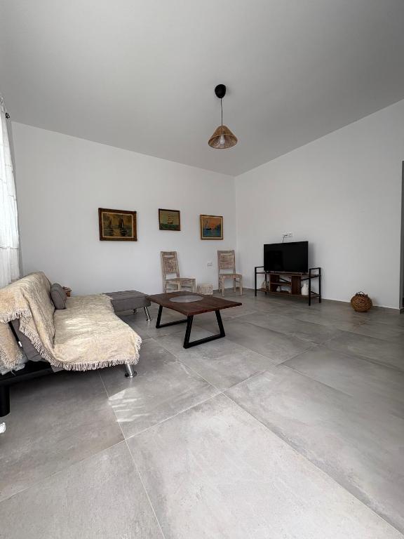 a living room with a couch and a table at NAXIAN OLIVE House in Glinado Naxos
