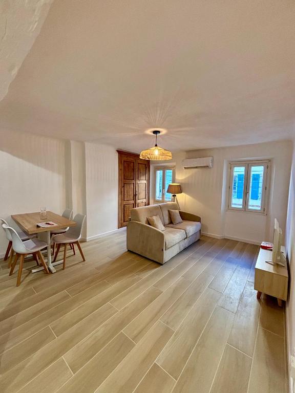 a living room with a couch and a table at L'Escale Auffan - Mourillon in Toulon