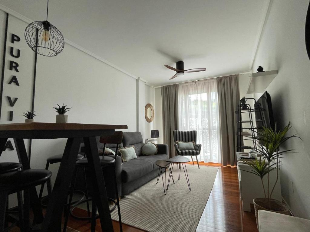 a living room with a couch and a table at Pura Vida Apartmento in Ramales de la Victoria