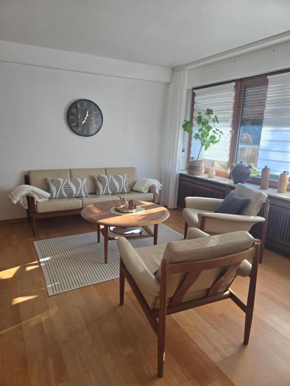 a living room with a couch and a table at Ferienwohnung mit kleinem Garten in Nettersheim