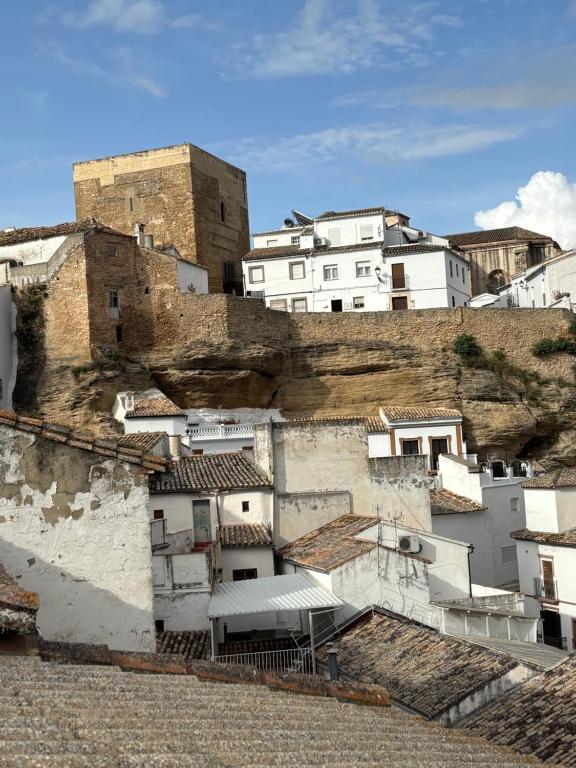a group of buildings on top of a hill at Casa del Abuelo in Setenil