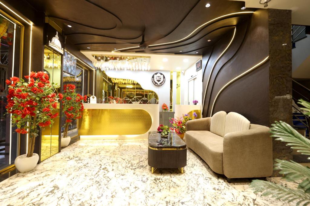 a lobby with a couch and a table and flowers at Hotel ELITE CHOICE in Ajmer