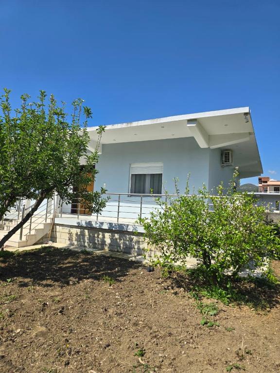 a white house with trees in front of it at Villa Ndoni in Berat