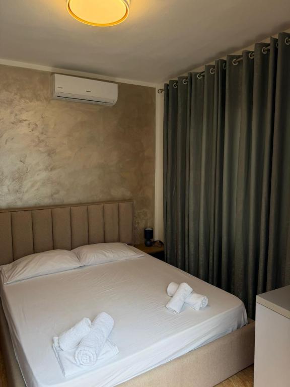 a bedroom with a bed with two towels on it at Aurea Rooms in Vlorë