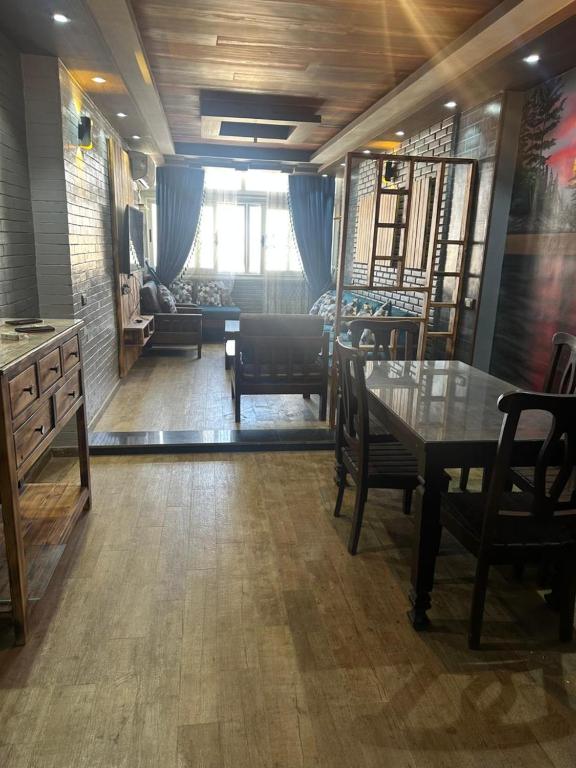 a living room with a table and chairs and a couch at Kimka in Aswan