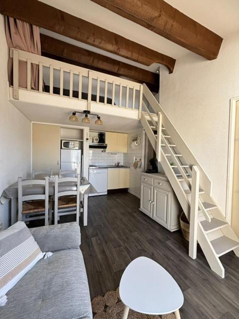 a living room with a loft bed and a kitchen at Maisonnette cosy à 400 m de la plage - Saint Cyprien in Saint-Cyprien-Plage