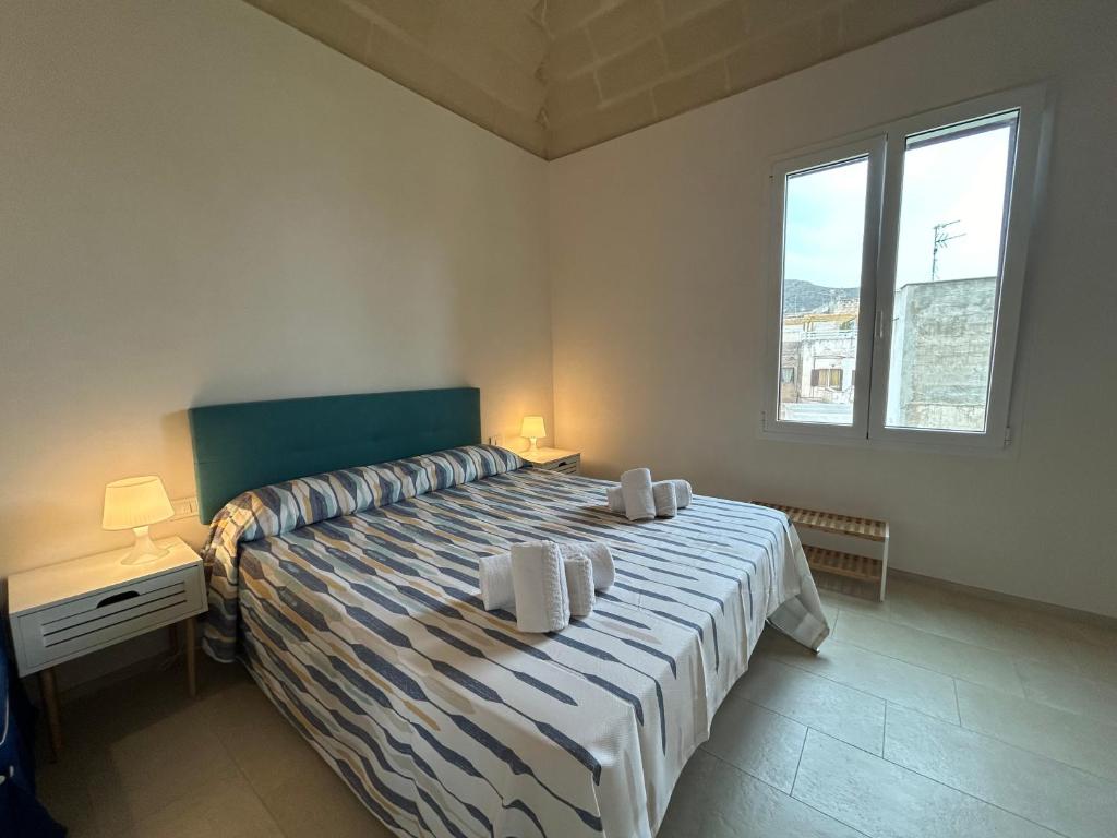 a bedroom with a bed with two pillows on it at Le Muciare in Favignana