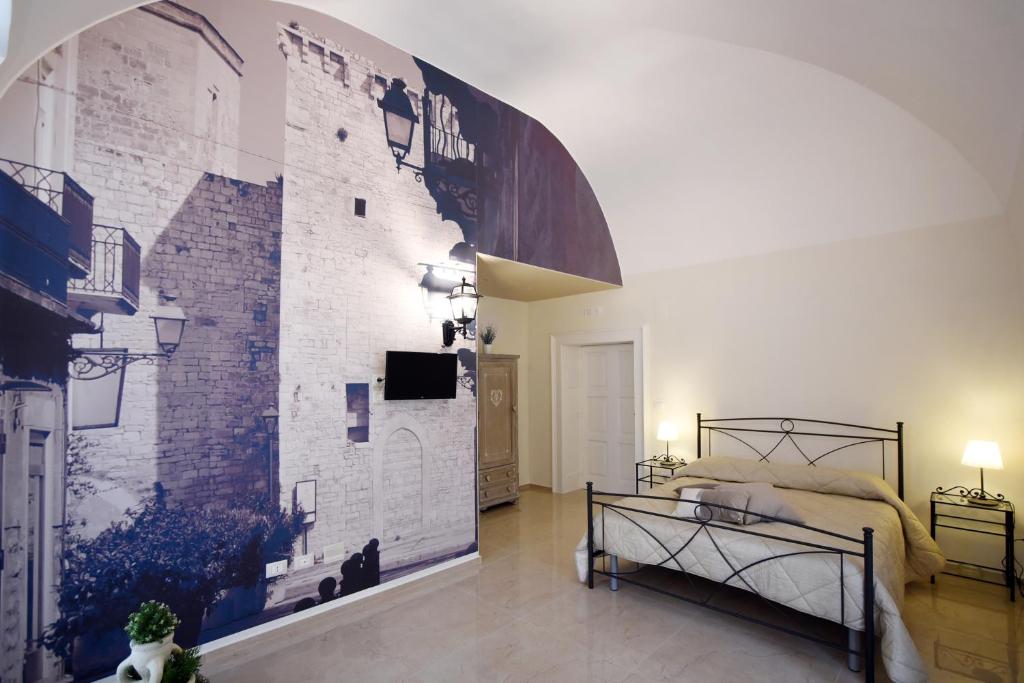 a bedroom with a wall with a brick wall at KAPSOTT B&B in Bisceglie
