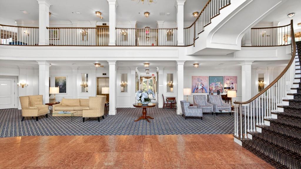 a lobby with a staircase and a living room at Avon Old Farms Hotel in Avon