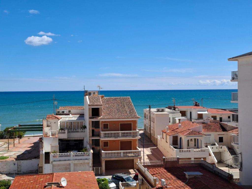 a group of buildings with the ocean in the background at Vista al Mar in Piles