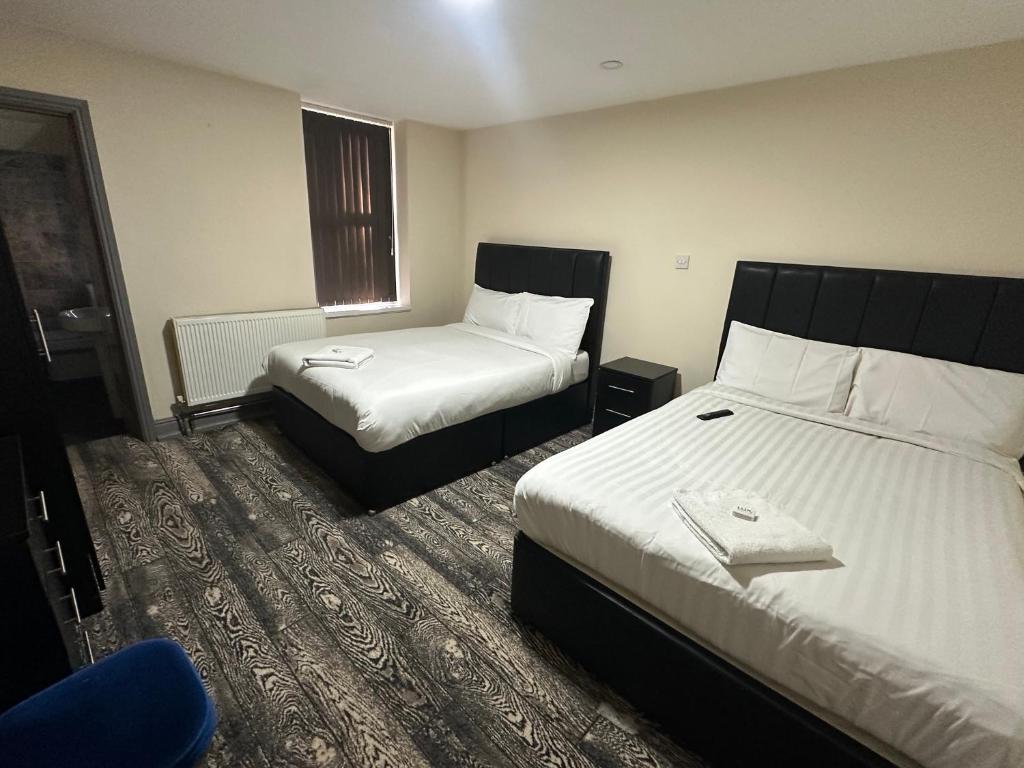 a hotel room with two beds and a chair at Park hotel in Bradford