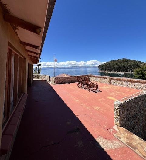 a walkway with a bench on the side of a building at Puma Punku Lodge in Isla Chillica