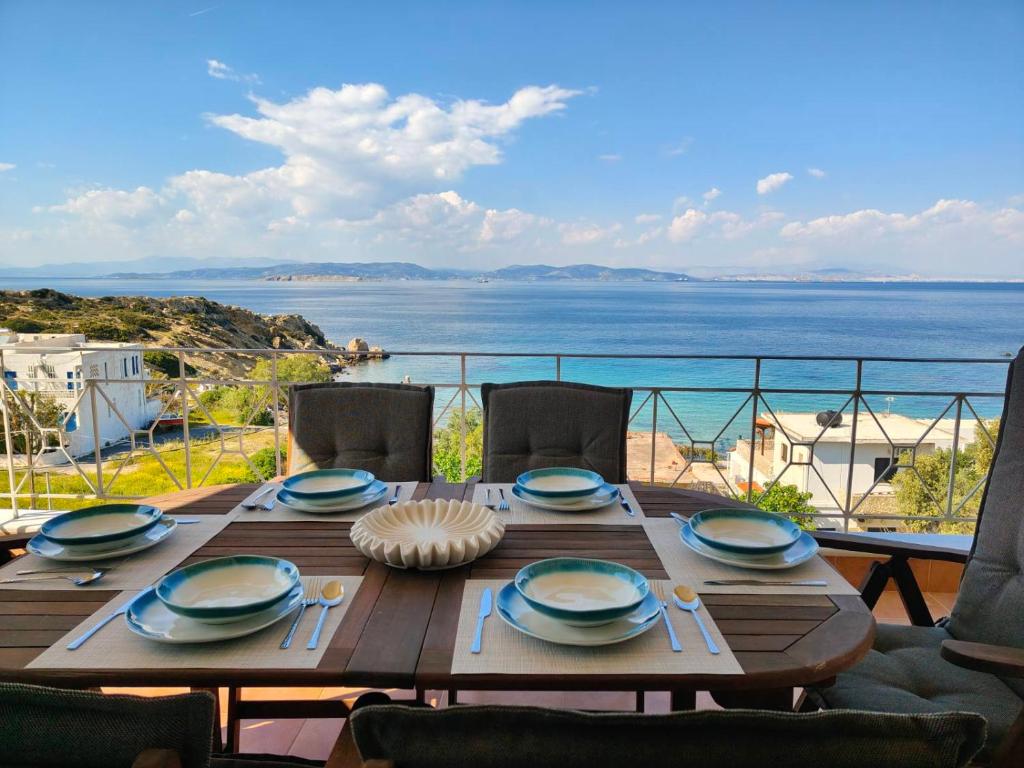 a wooden table with a view of the ocean at The View in Souvala