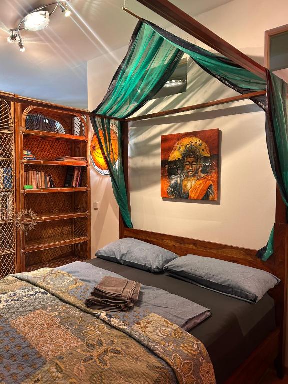 a bedroom with a bed and a painting on the wall at Surya Villa Holistic Stay Prenzlauer Berg in Berlin
