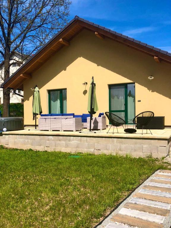 a house with two chairs and two umbrellas at Prázdninový dům Dírná in Dírná